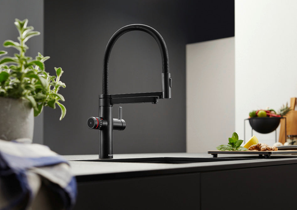 BLANCO Evol-S Pro 4-in-1 Boiling Water Kitchen Tap in Black Matt on a Kitchen Island
