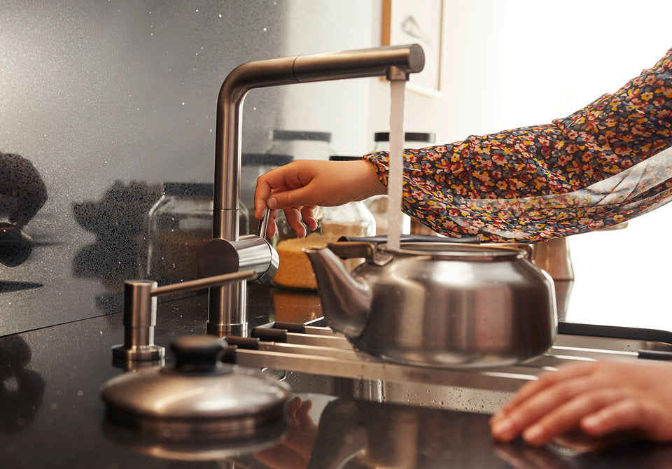 BLANCO Linus-S Single Lever Kitchen Mixer Tap with Pull-Out Spray Filling a Kettle at the Sink