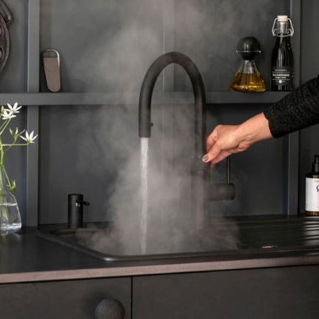 QUOOKER FLEX TAP in black in a modern kitchen setting demonstrating the boiling water feature
