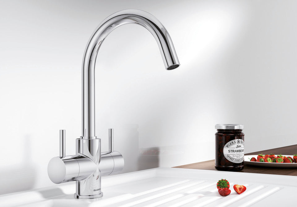 BLANCO Camia Dual Lever C-Shaped Kitchen Mixer Tap in Chrome on a White Sink Drainer
