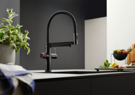 BLANCO Evol-S Pro 4-in-1 Boiling Water Kitchen Tap in Black Matt on a Kitchen Island