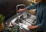 BLANCO Jandora Single Lever Kitchen Mixer Tap Filling a Vase at a Stainless Steel Sink
