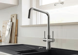 BLANCO Jax Dual Lever Kitchen Mixer Tap in PVD Steel in Front of a Window