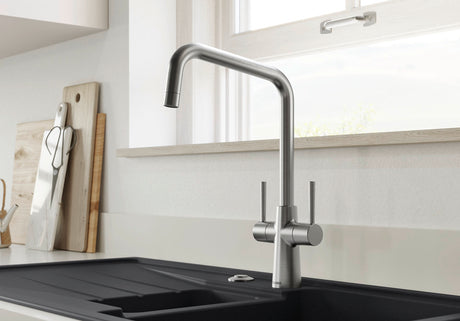 BLANCO Jax Dual Lever Kitchen Mixer Tap in PVD Steel in Front of a Window