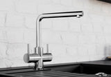 BLANCO Lamia Dual Lever Kitchen Mixer Tap in Chrome against a White Brick Wall