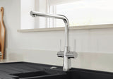 BLANCO Lax Dual Lever Kitchen Mixer Tap with 360° Swivel Spout in Chrome in Front of a Window