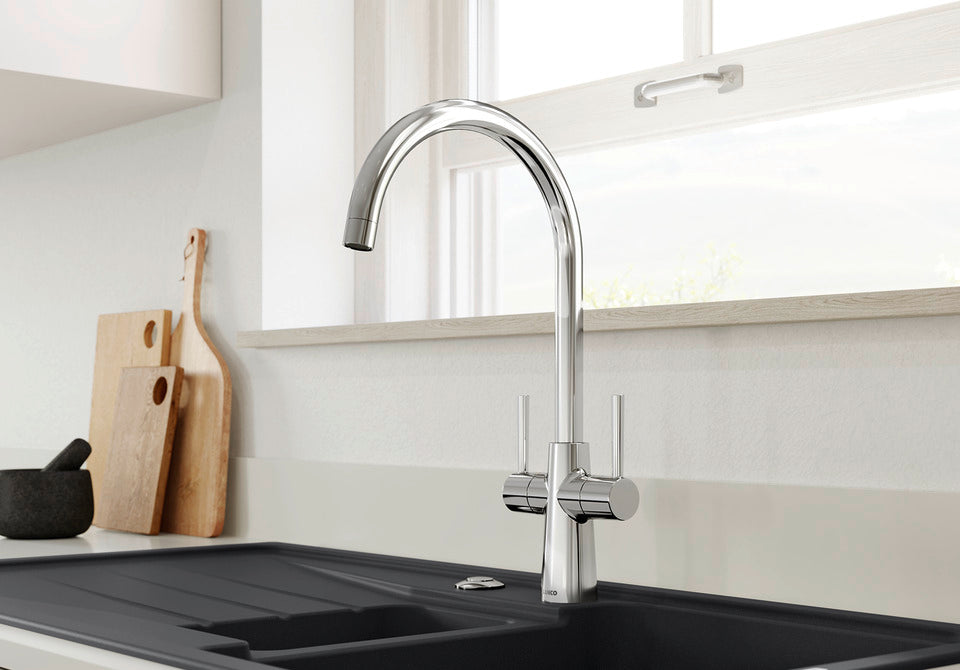 BLANCO Max II Dual Handle Kitchen Mixer Tap with 360° Swivel Spout in Chrome in Front of a Window