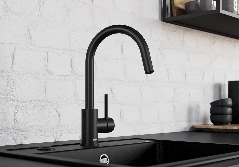 BLANCO Mida-S Single Lever Kitchen Mixer Tap with Pull-Down Handspray in Black Matt against a White Brick Wall