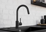 BLANCO Mida-S Single Lever Kitchen Mixer Tap with Pull-Down Handspray in Black Matt against a White Brick Wall