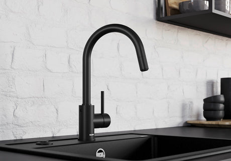 BLANCO Mida-S Single Lever Kitchen Mixer Tap with Pull-Down Handspray in Black Matt against a White Brick Wall
