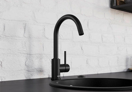 BLANCO Mida Eco-Flow Single Lever Kitchen Mixer Tap in Black Matt against a White Brick Wall