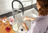 BLANCO Sonea S-Flexo Single Lever Kitchen Mixer Tap with Pull Out Spray Filling a Glass at the Sink
